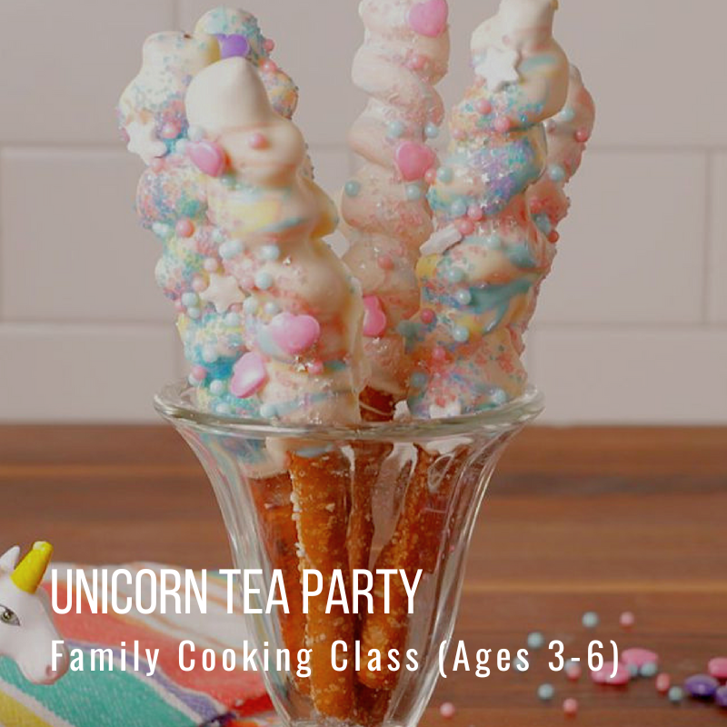 Colorful pretzel sticks with unicorn decorations in a glass cup.