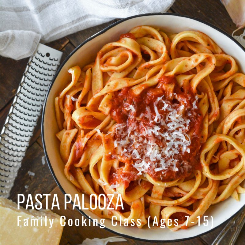 Bowl of pasta with tomato sauce and grated cheese.