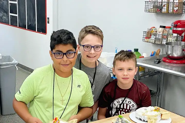 a person sitting at a table with a birthday cake