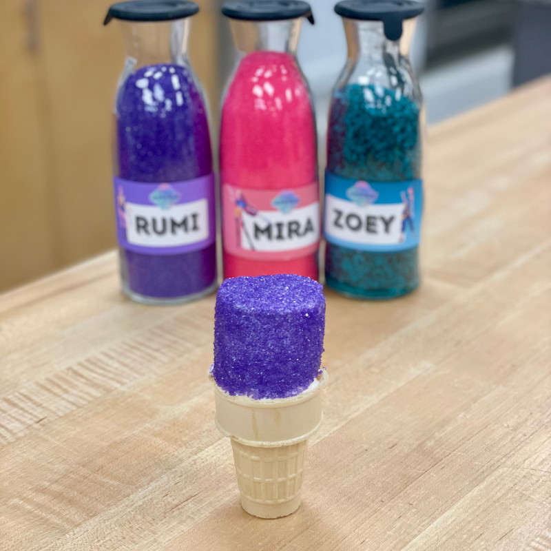 Purple covered ice cream cone with jars labeled Rumi, Mira, and Zoey in the background.