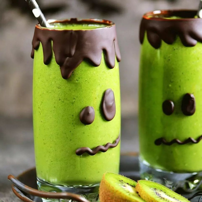 Green smoothies with chocolate edges, decorated as Frankenstein faces.
