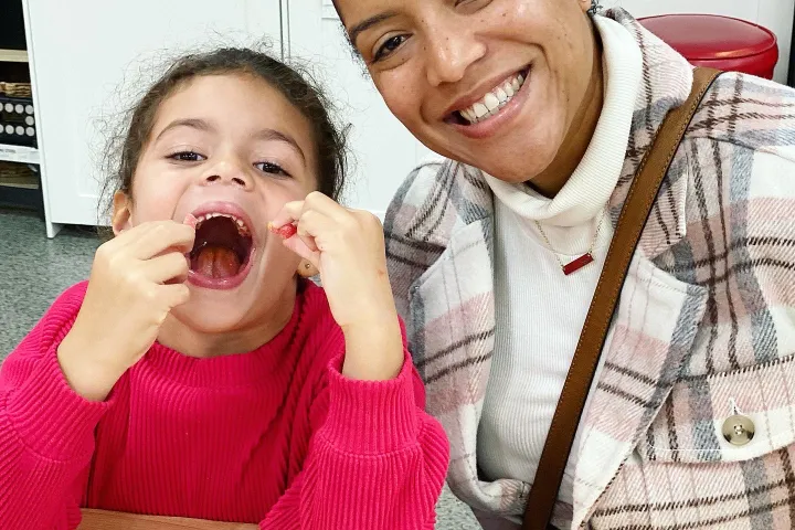 a young girl eating a donut