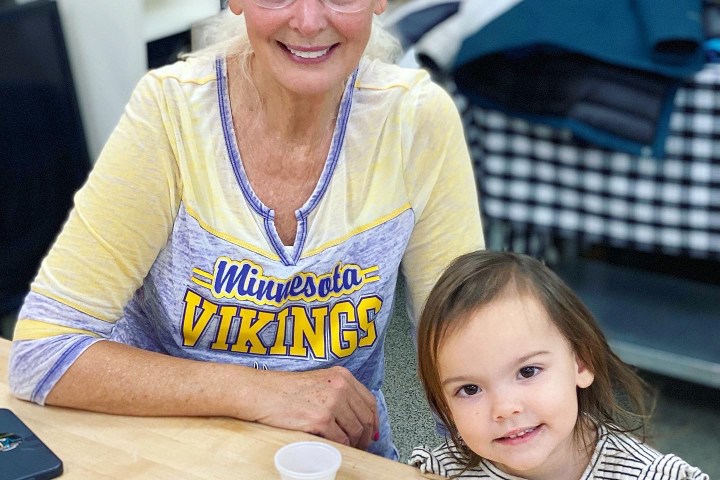 a person sitting at a table with a birthday cake