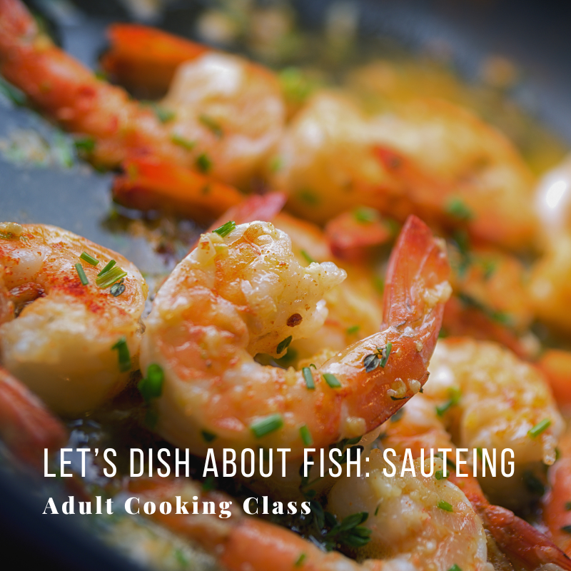 Close-up of sauteed shrimp garnished with herbs in a pan.