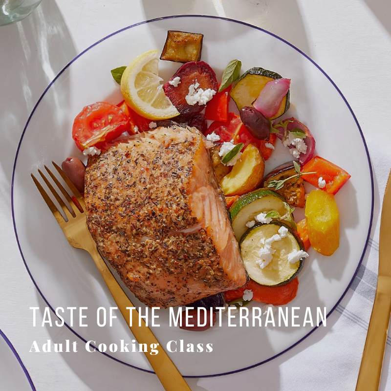 Grilled salmon and vegetables on a plate with cutlery.