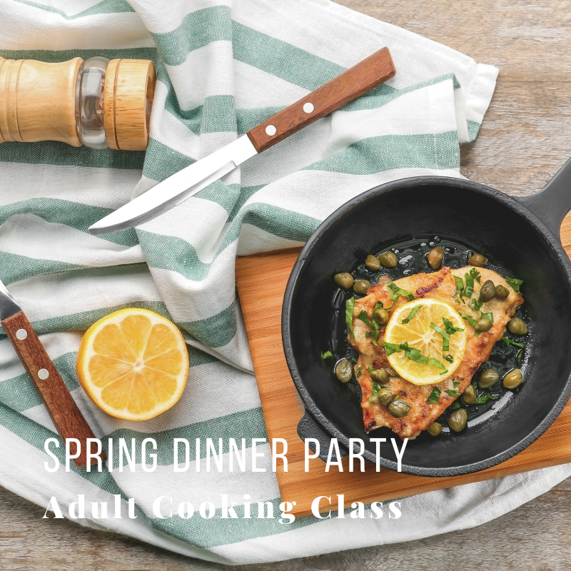 Cooked fish with lemon in skillet, knife, pepper mill, and text on striped cloth.