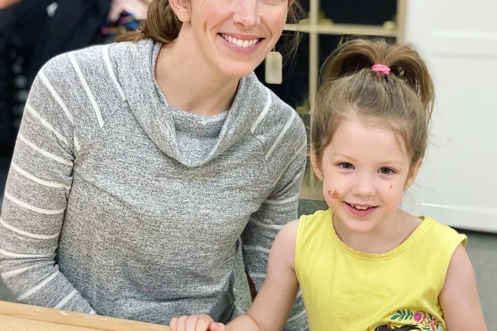 a boy and a girl sitting on a table