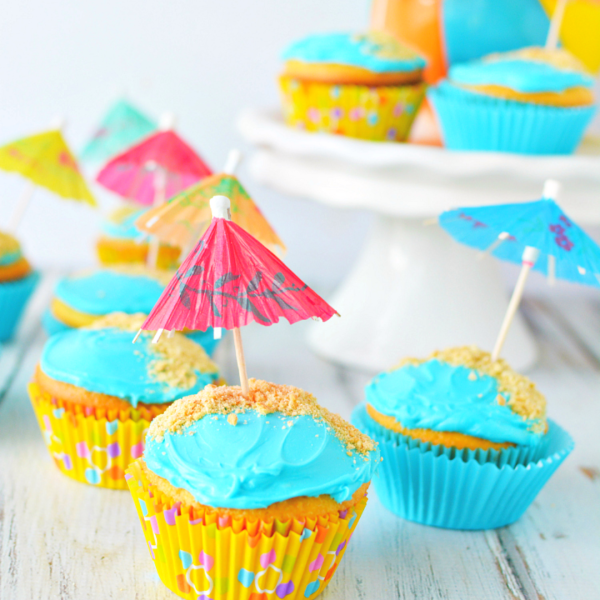 a blue birthday cake with lit candles