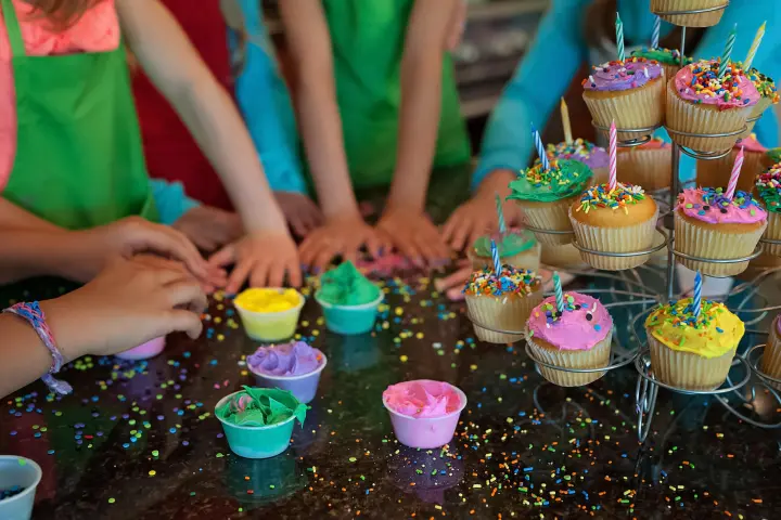 a woman sitting at a table with a birthday cake