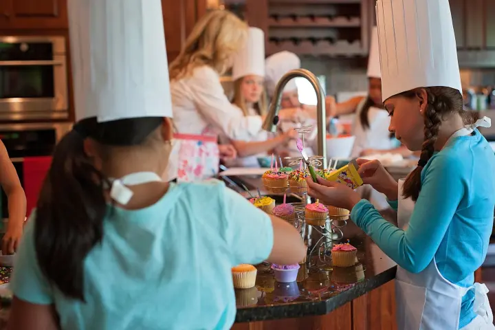 a woman holding a birthday cake