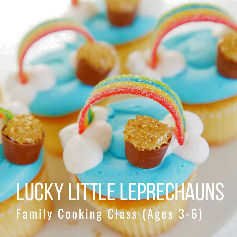 Cupcakes with blue icing, candy rainbows, and gold sprinkle pots.