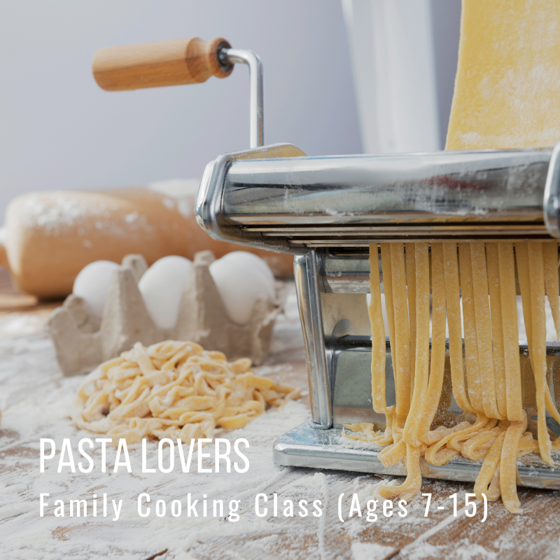 A pasta maker with fresh pasta, eggs, and flour on a table.