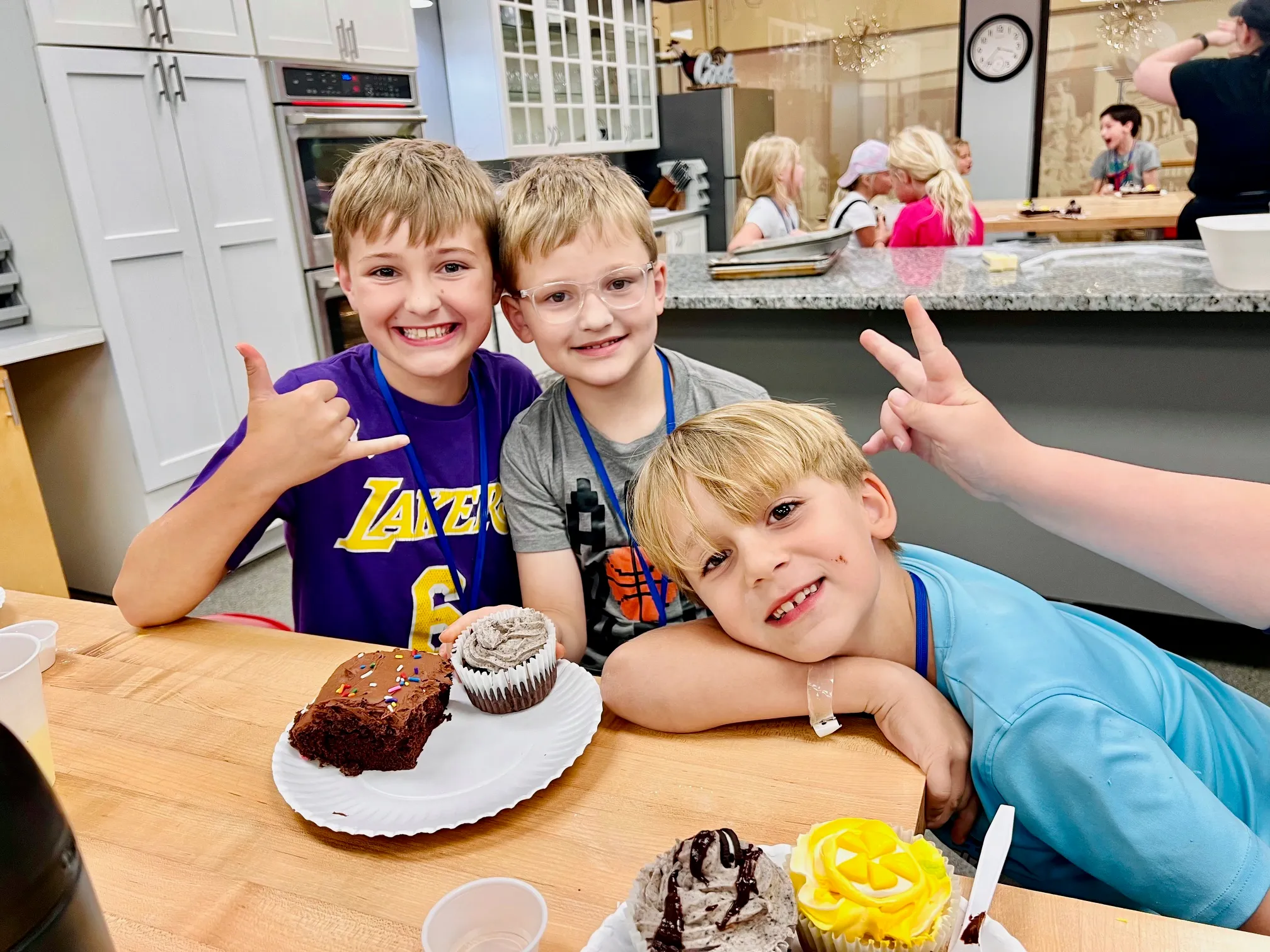 a little girl sitting at a table with a cake