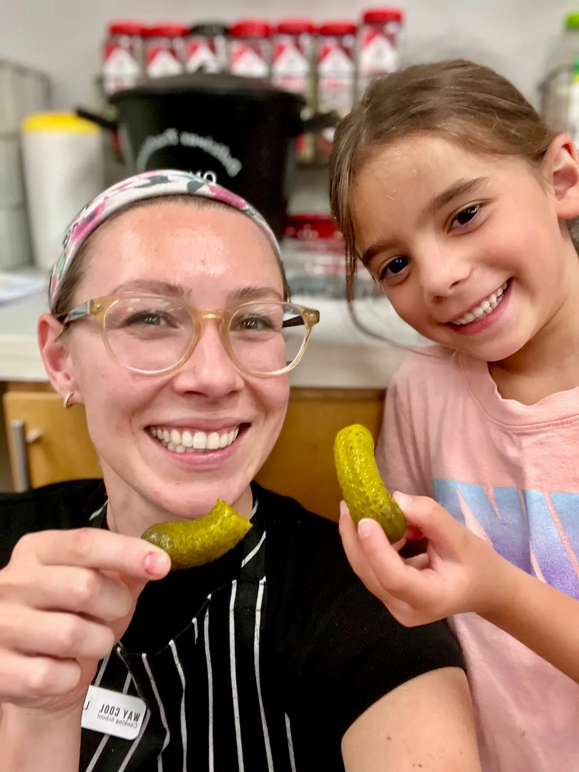 a little girl holding a banana