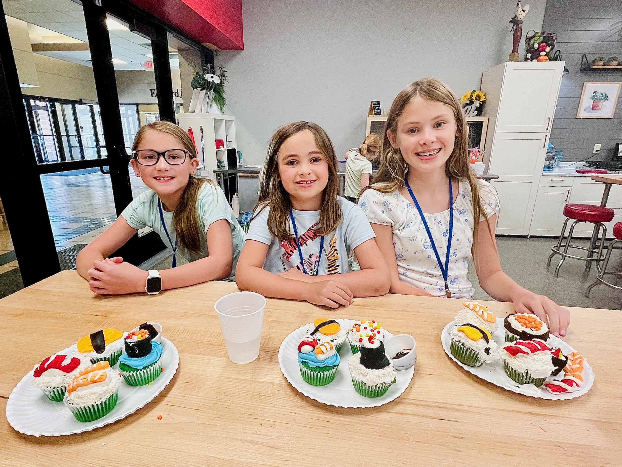 a woman sitting at a table with a birthday cake