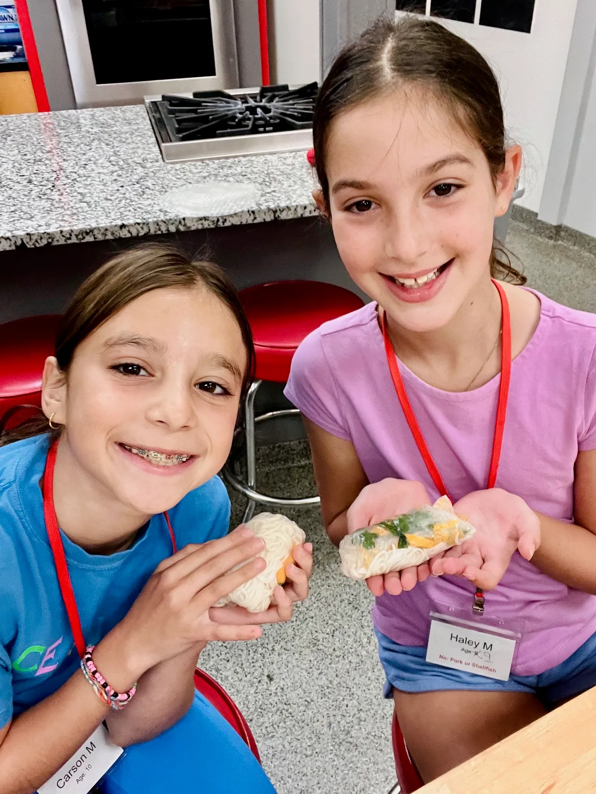 a little boy sitting at a table eating food