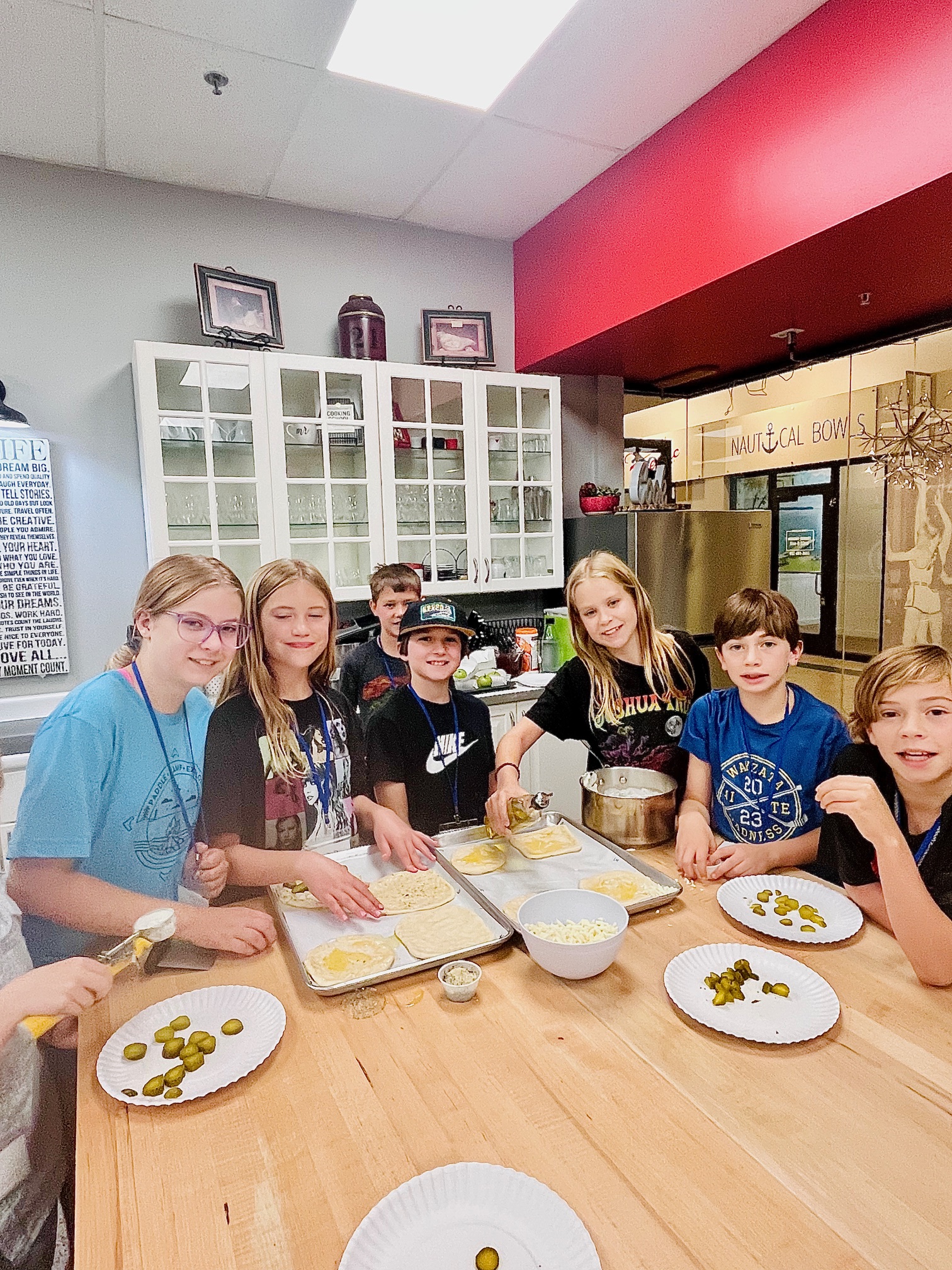 a group of people sitting at a table eating food