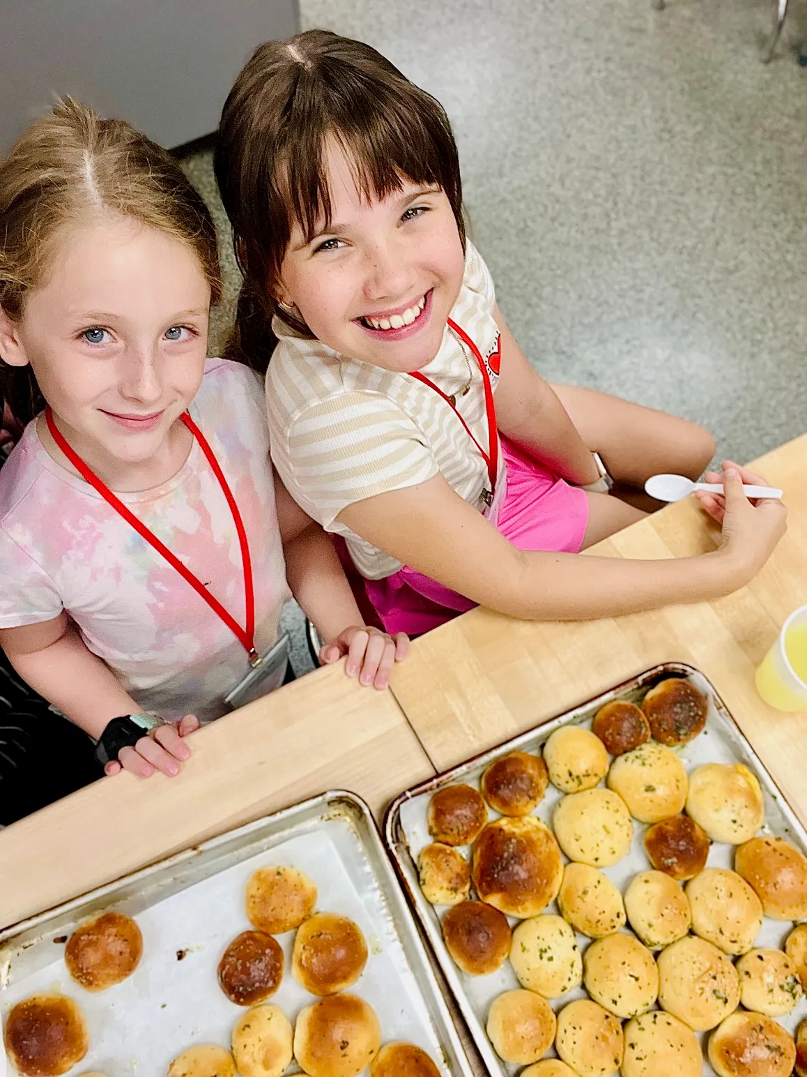 a group of young children sitting next to a box of pizza