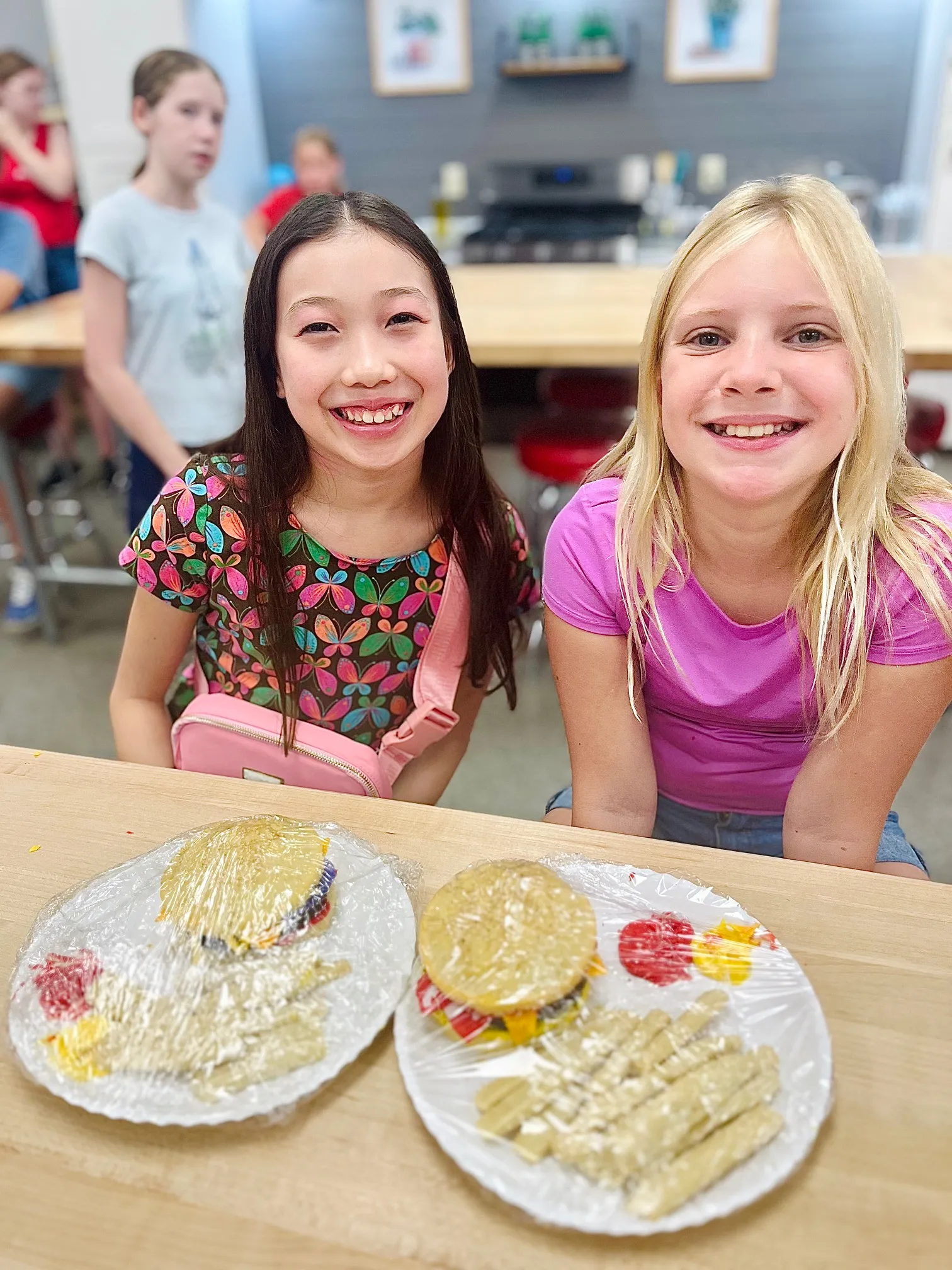 a woman sitting at a table with a cake