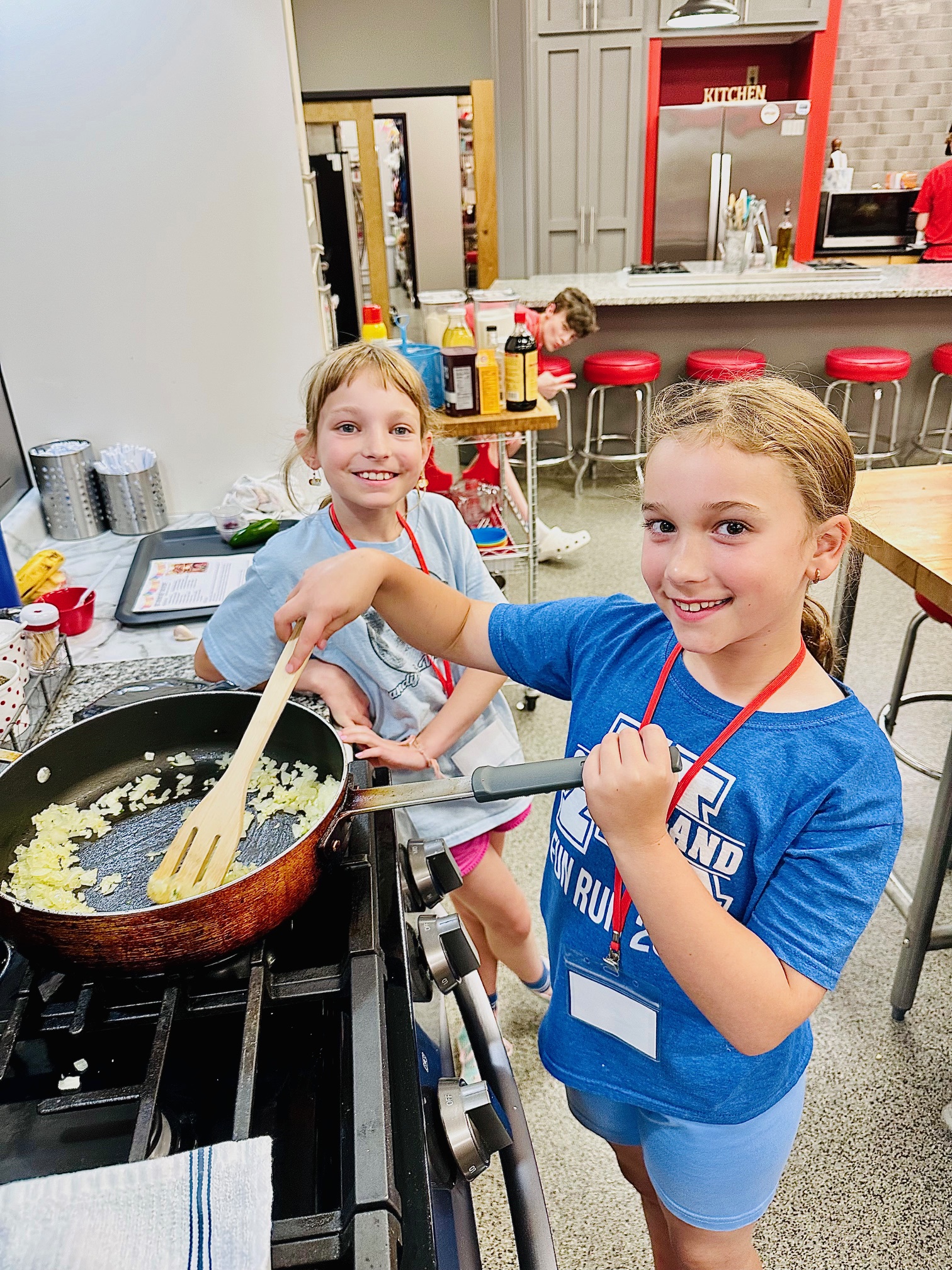 a little boy that is standing in the kitchen