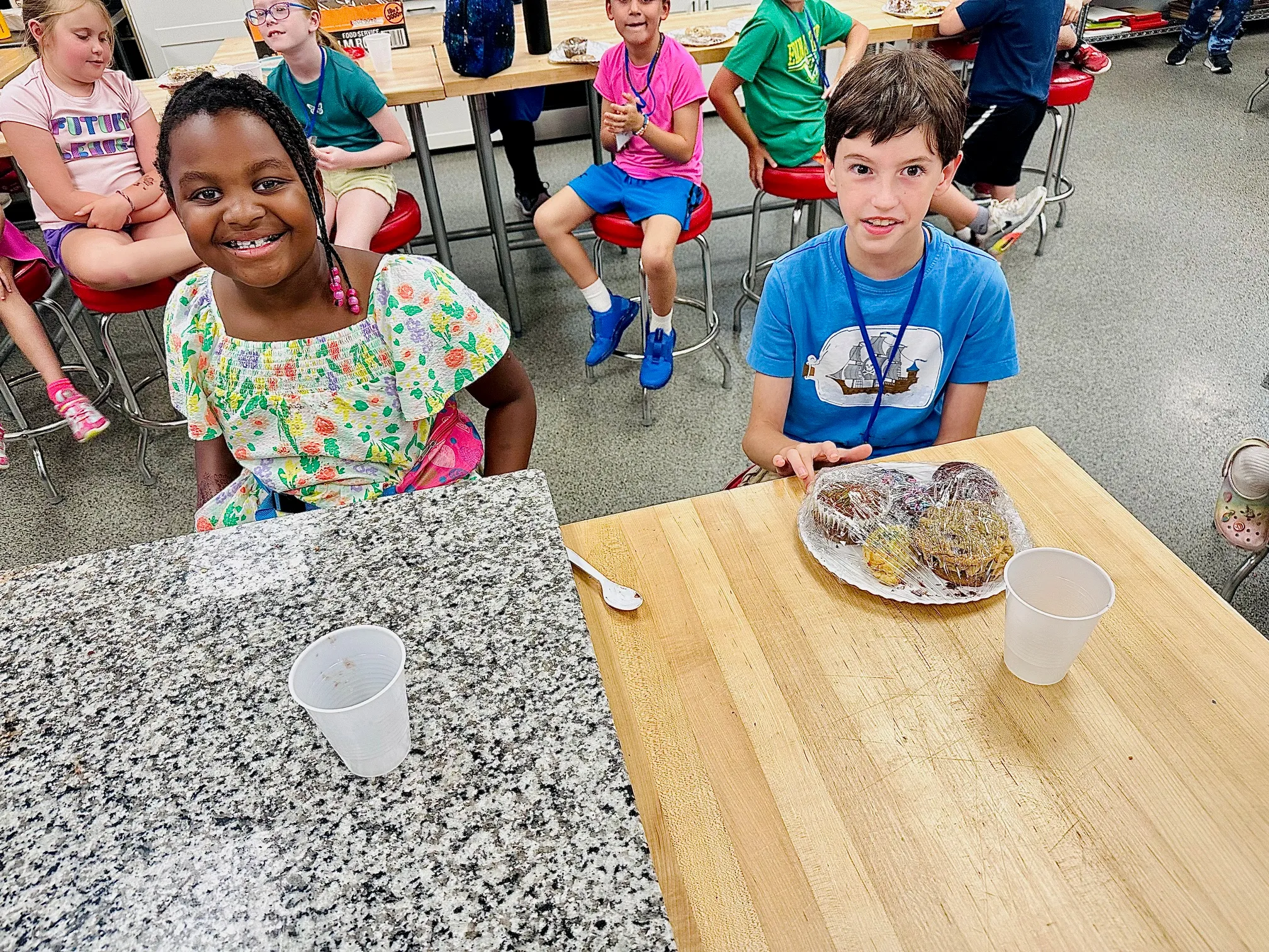 Emmanuel Lewis et al. sitting at a table with a cake