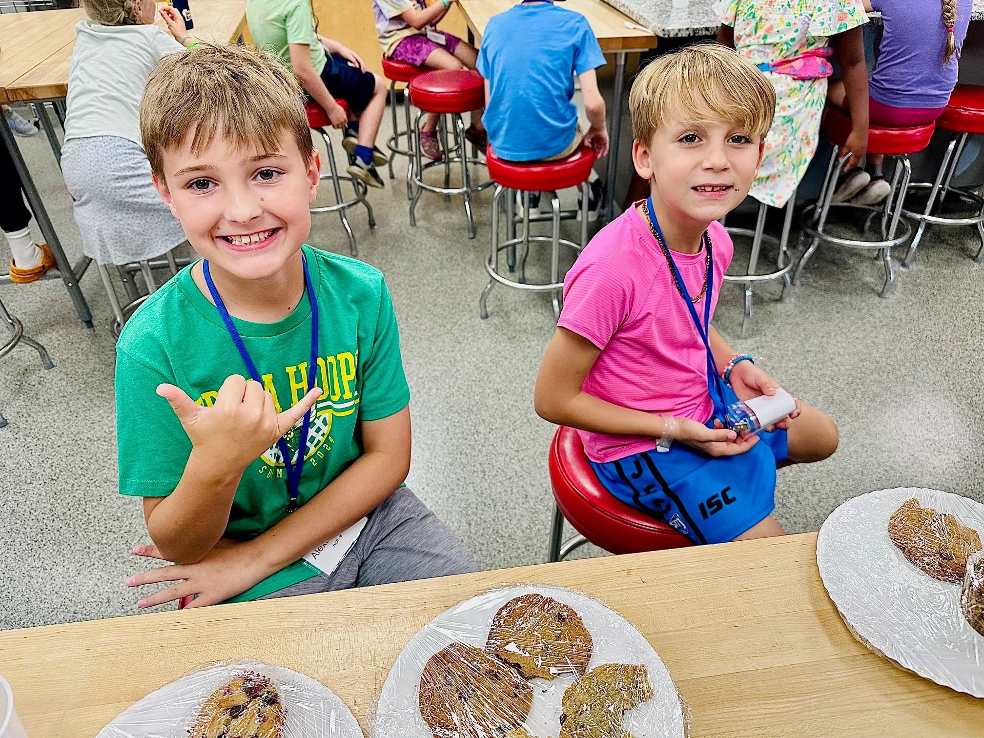 a little boy sitting at a table eating cake