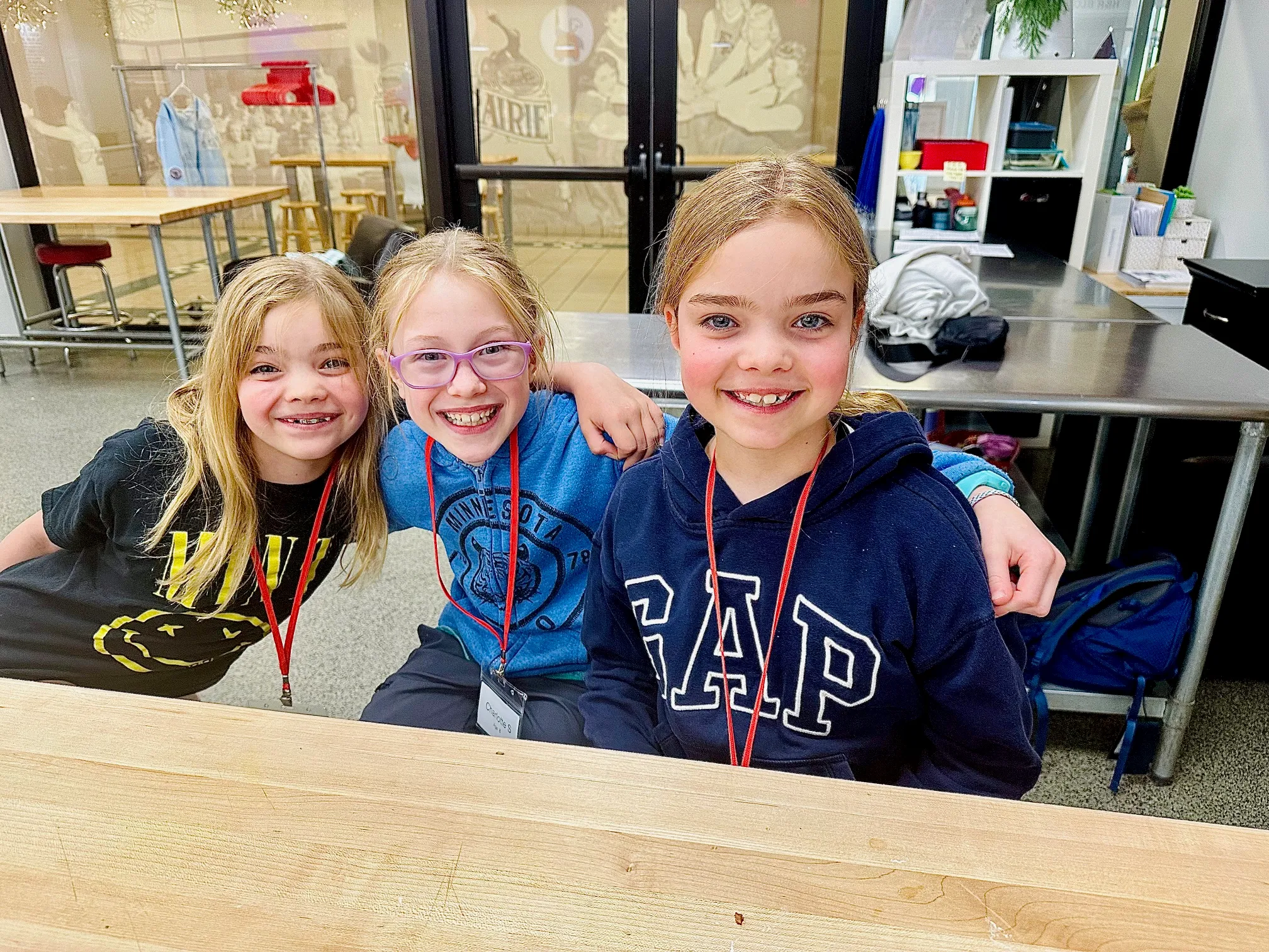a little boy sitting at a table posing for the camera