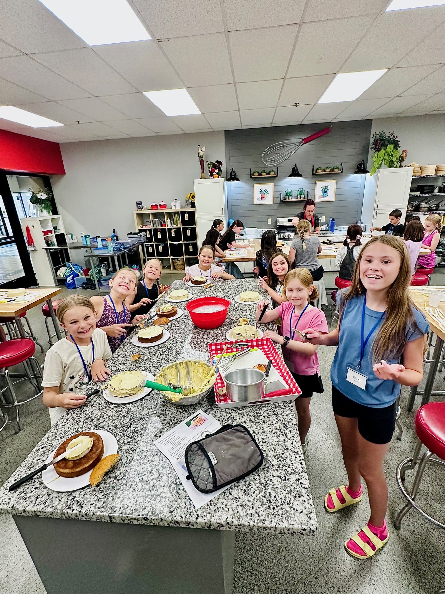 a group of people standing in a kitchen