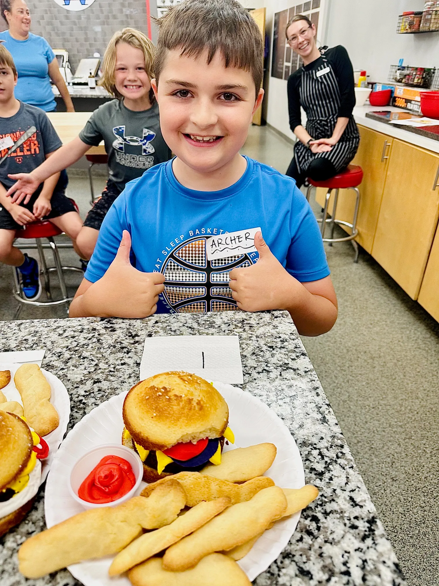 a group of people sitting at a table with a plate of food