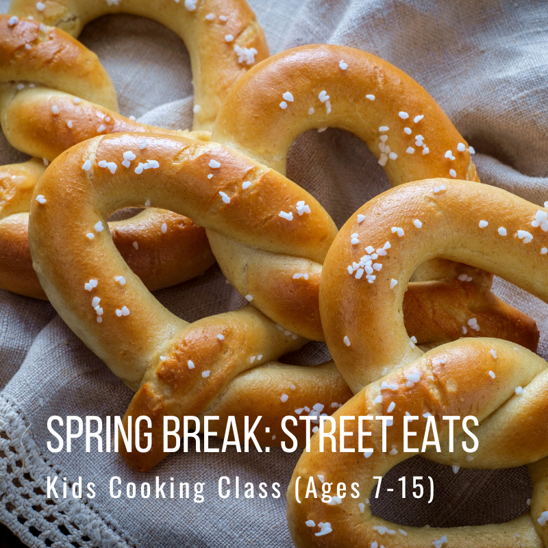Salted pretzels on cloth with text: 'Spring Break: Street Eats, Kids Cooking Class (Ages 7-15)'.