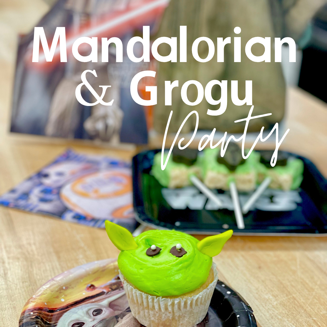 Green Yoda cupcake at themed party with decorations.