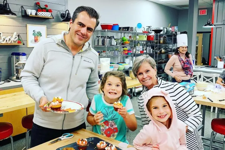 Patrick Gavin et al. sitting at a table with a cake