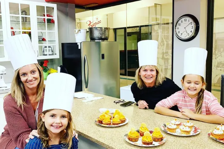 a group of people sitting at a table posing for the camera