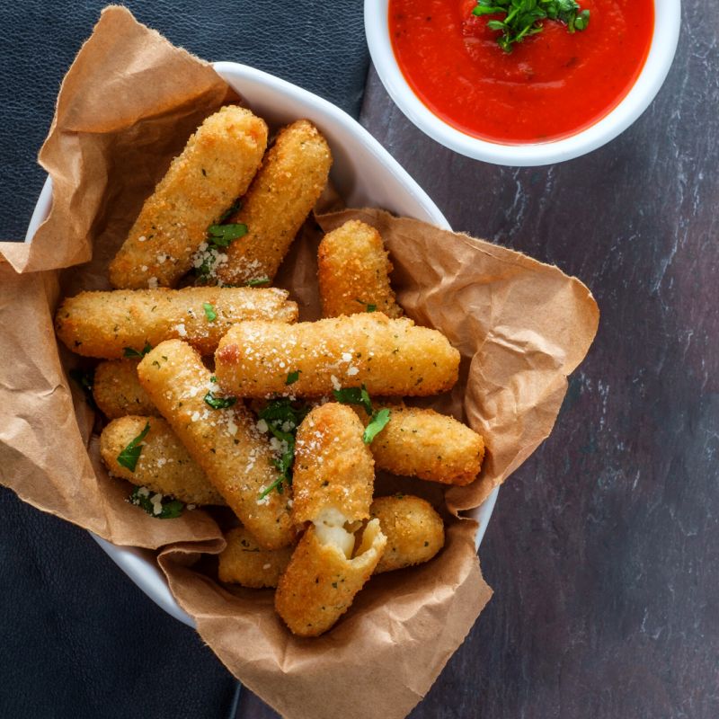a tray of hot dogs with different toppings sitting on a table