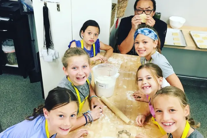 a group of young children sitting next to a child