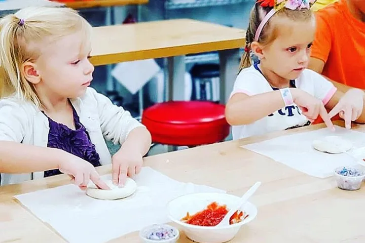 a little boy sitting at a table