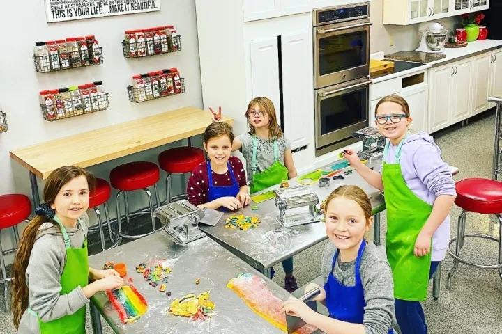 a little girl sitting on a table