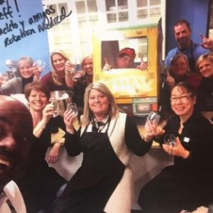 a group of people standing in front of a crowd posing for the camera