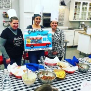 a group of people standing around a table