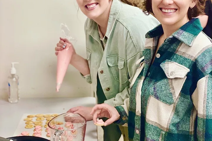 a couple of people that are standing in the kitchen