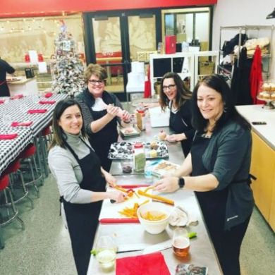 a group of people sitting at a table with food