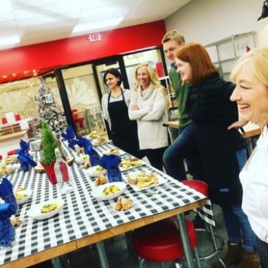 a group of people standing around a table