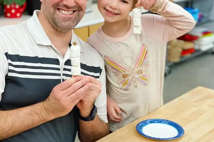 a man and a woman standing on a table