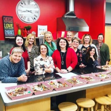 a group of people sitting at a table posing for the camera
