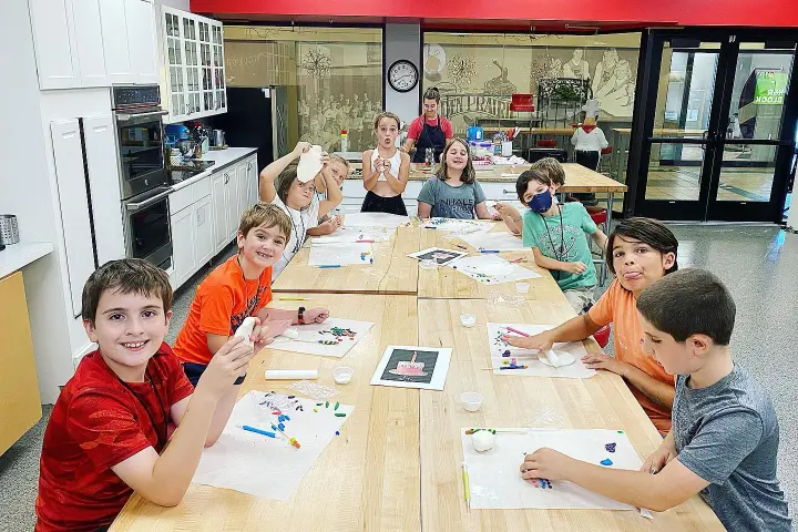 a young boy sitting on a table