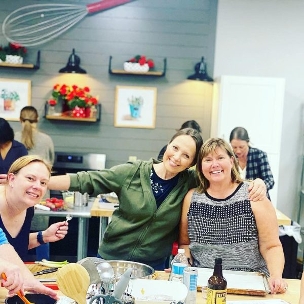 a group of people standing around a table