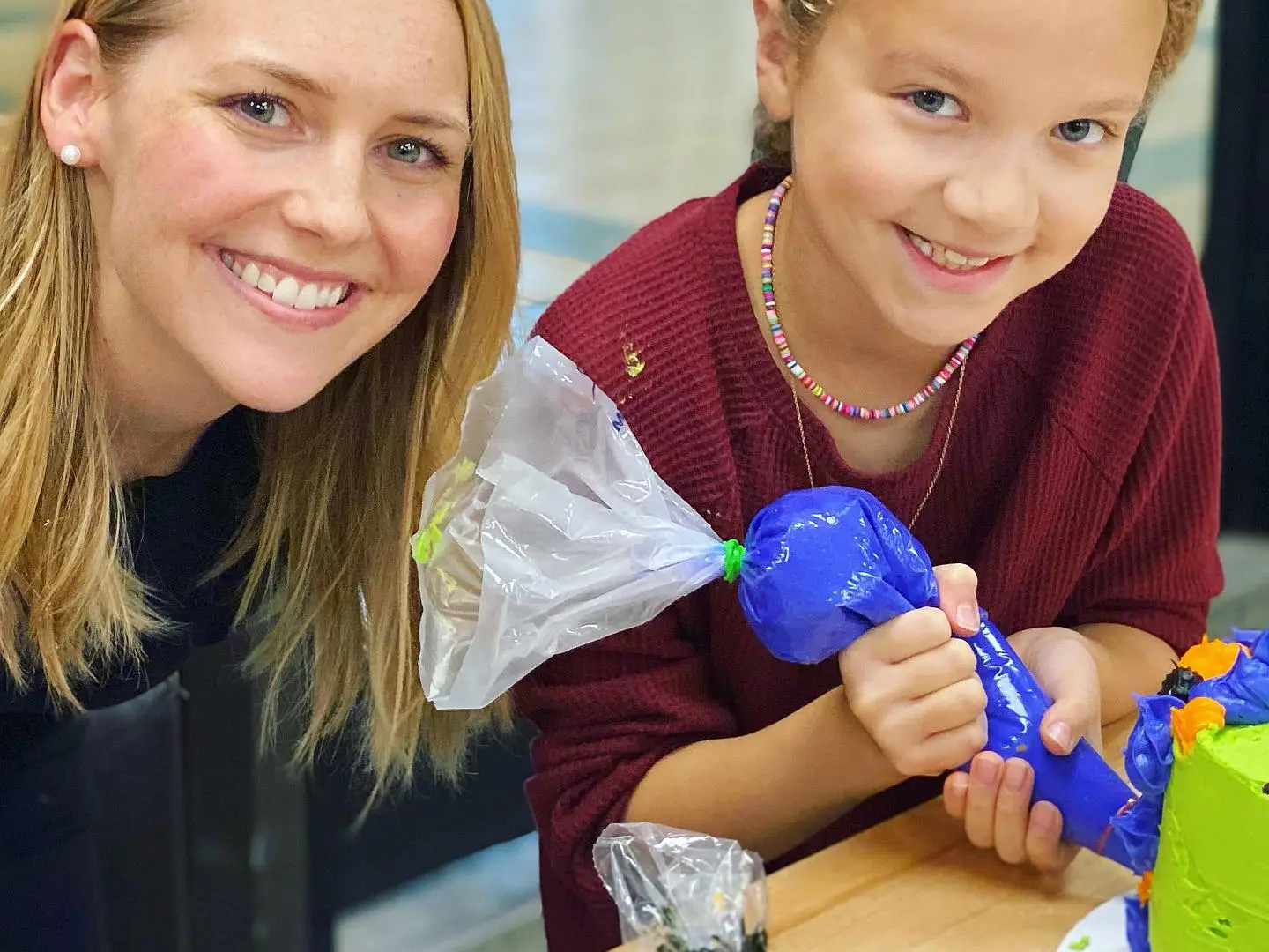 a couple of little girls sitting on a table
