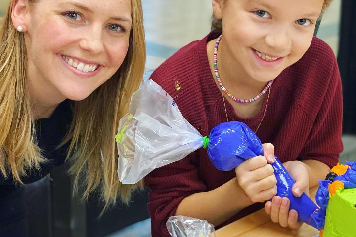 a couple of little girls sitting on a table