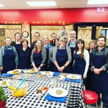 a group of people standing in front of a crowd posing for the camera