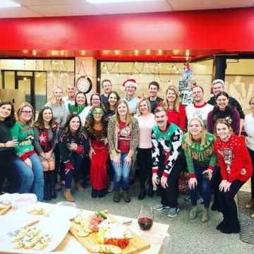 a group of people standing in front of a crowd posing for the camera